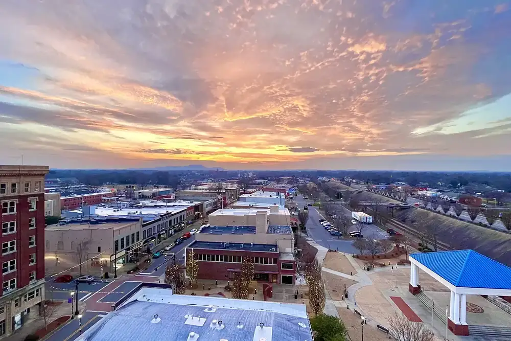 Aerial view of downtown Gastonia, North Carolina, with streets and rooftops at sunset