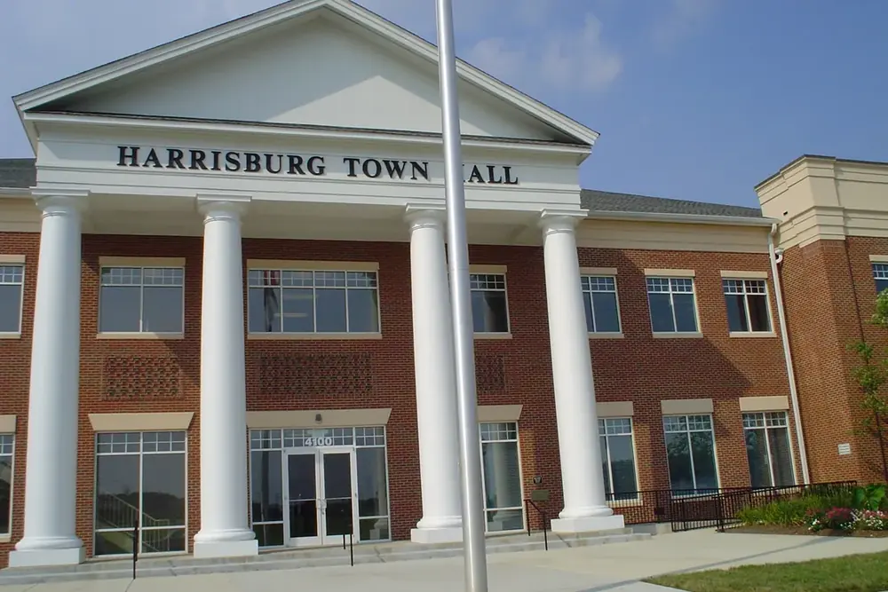 Columned brick front of Harrisburg Town Hall in Harrisburg, North Carolina