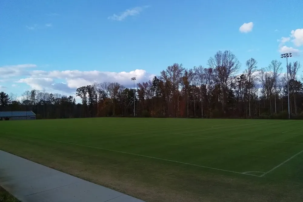 Open grass playing field and tree line at the Sportsplex at Matthews, North Carolina